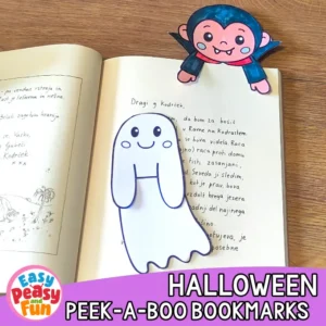 An open book featuring a colored vampire bookmark and an uncolored ghost bookmark template resting on the pages.